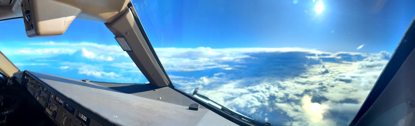Flight deck view above the clouds at cruise altitude